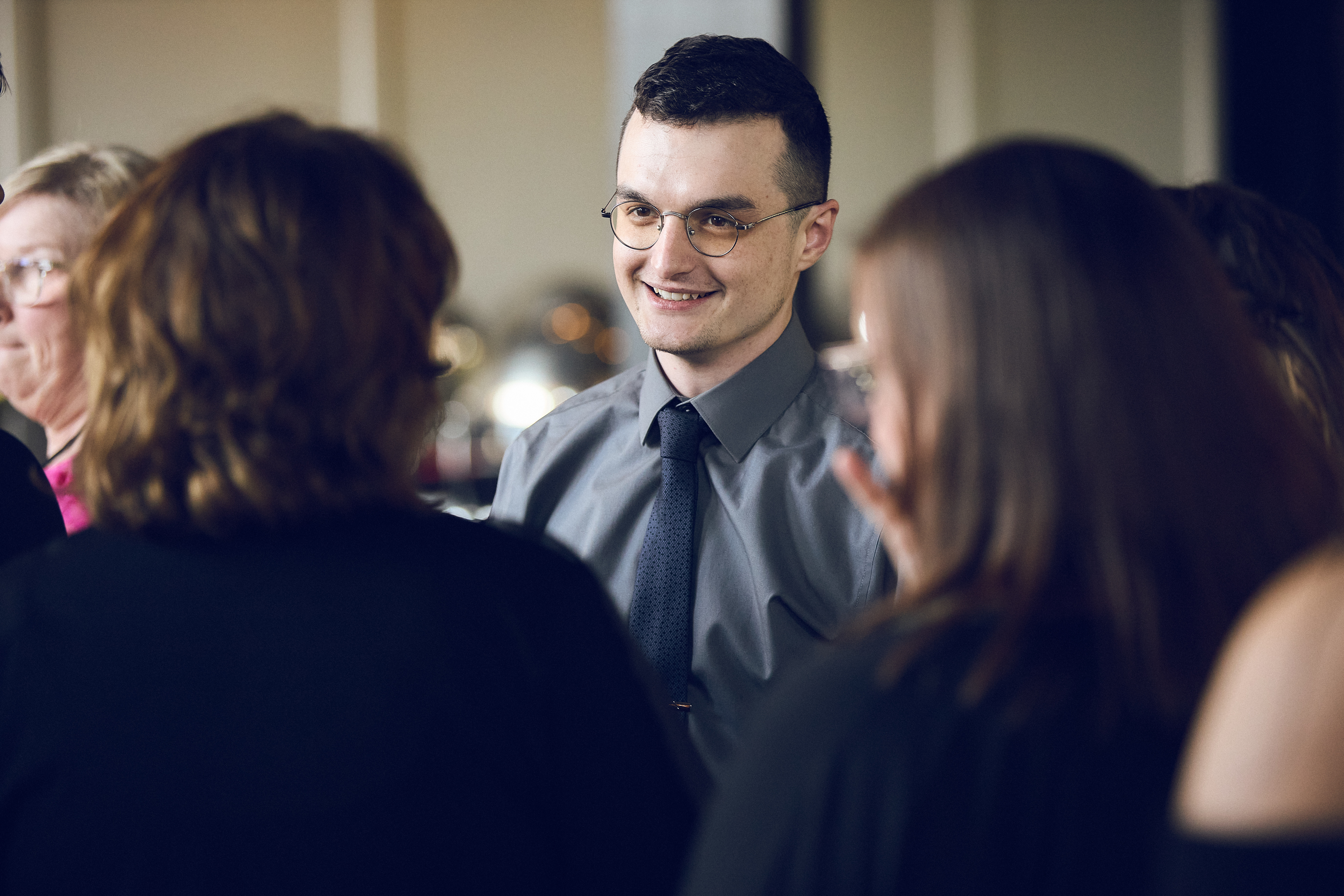 A small group of Titus employees having a conversation at an event
